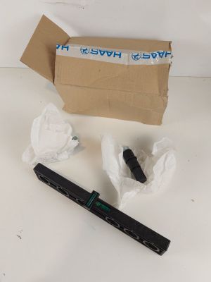 une boîte contenant un bout de papier, un stylo et une paire de ciseaux, posée sur une table