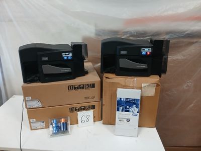 deux imprimantes posées sur des cartons, sur une table