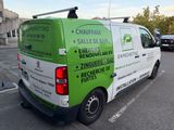 a green and white van that is parked in a parking lot