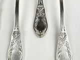 four spoons and two spoons sitting on a table