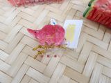 a pink bird that is sitting on top of a piece of watermelon