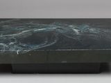a close up of a black marble table on a white background