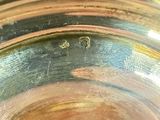 a close up of a silver plate with a gold rim