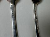 three spoons that are sitting on a table