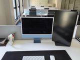 a desk with a keyboard, monitor, and mouse on it