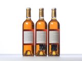 three bottles of wine sitting on top of a table next to each other