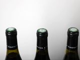 three bottles of wine that are sitting on a table