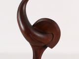 an image of a wooden sculpture of a bird on a wooden base