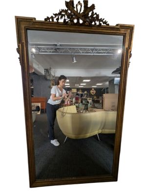 a woman taking a picture of herself in a mirror