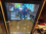 a small refrigerator with a glass door in a kitchen