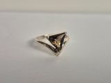 a close up of a silver ring on a white surface