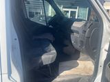 a white van with the door open and the driver ' s seat down