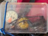 a clear box with a gauge and a pair of shoes in it