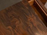 a close up of a wooden table with a drawer