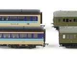 two trains that are sitting side by side on a white surface