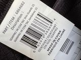 a label on a black jacket with a barcode on it