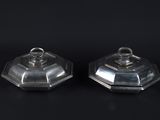 a pair of silverplated salt and pepper shakers on a black background
