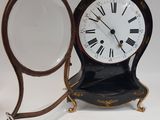 a clock that is sitting on a table next to a mirror