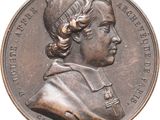 an image of a bronze medal of a man with a hat on