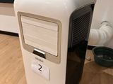 a small computer on the floor in front of a tv