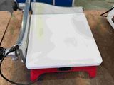 an image of a scale on a table in a room