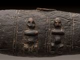 a close up of a wooden object with carvings on it