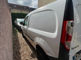 a white van that is parked next to a building