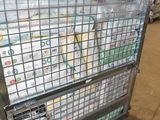 a large metal cage with a bunch of papers in it
