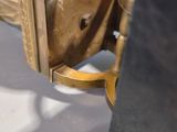 a gold gun that is on display on a white table