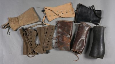 six pairs of leather boots and a pair of leather gloves