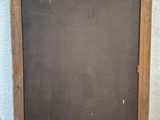 a blackboard on the floor next to a white wall