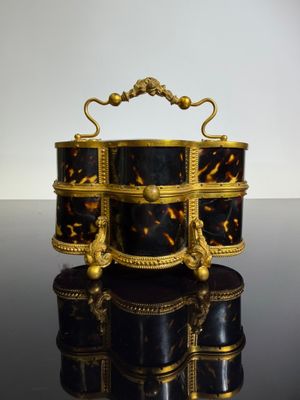a black and gold box with a handle on top of it