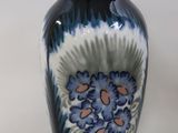 a vase that has a blue and white design on it