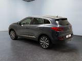 the rear view of a grey car parked in a room