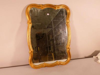 a mirror that is sitting on a shelf in a room