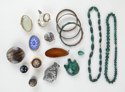 many different types of jewelry displayed on a white surface