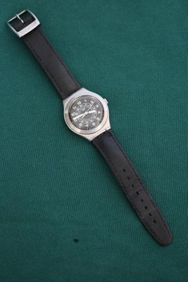 a close up of a wrist watch on a green surface