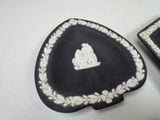 two black and white heart shaped dishes with a crown on them