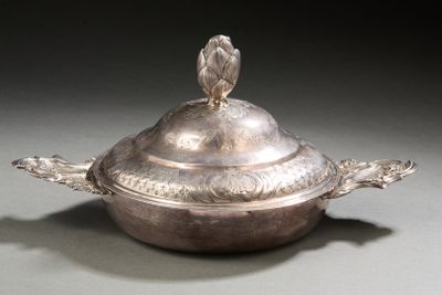 a silver dish with a bird on top of it