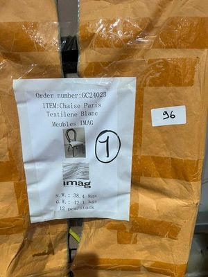 a sign on the back of a chair that is wrapped in plastic