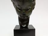 sculpture of a head of a child on a black marble base