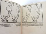 an open book with a drawing of antelope on it