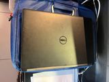 a laptop that is sitting on top of a blue bag