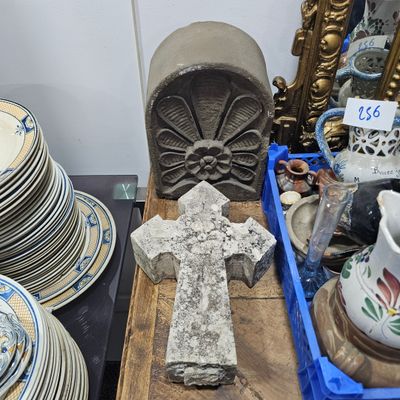 a cross on a table with a lot of plates and cups