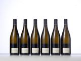 six bottles of wine lined up in a row on a table