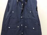 the jacket is hanging on a hanger on the wall
