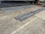 a pile of steel rods sitting on top of a cement floor