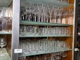 many wine glasses on the shelves in the room