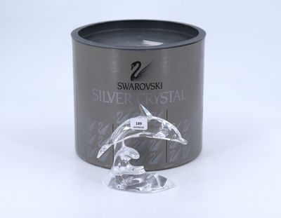 swarovski silver crystal candle in a tin with a dolphin figurine