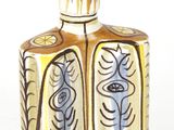 a small bottle with a flower design on it